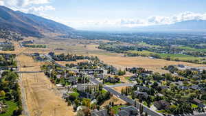 Aerial view of property's location featuring a mountain backdrop and nearby suburban area
