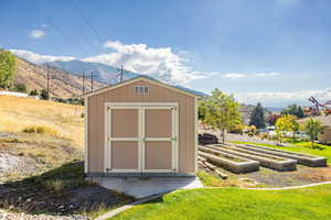 View of shed featuring a garden and a mountain view