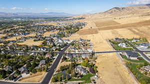 Aerial overview of property's location with nearby suburban area and mountains
