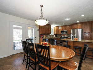 Dining area with a textured ceiling and recessed lighting