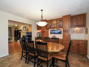 Dining area featuring a textured ceiling and ornamental molding