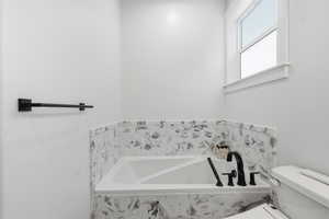 MASTER: Full bathroom with a bath and toilet