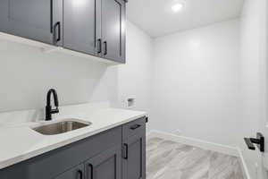 Laundry area featuring cabinet space, hookup for a washing machine, and recessed lighting