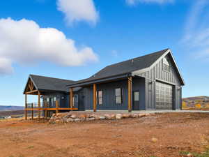 South view of home and garage with porch and deck