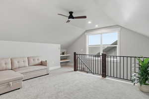 ABOVE GARAGE: Bonus room featuring light colored carpet, lofted ceiling, ceiling fan, and recessed lighting