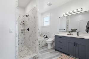 MASTER: Full bathroom with a garden tub, vanity, and a marble finish shower