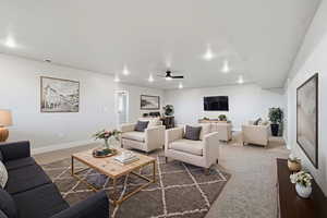 Virtual Staged: Carpeted living area featuring a ceiling fan and baseboards