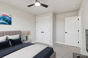 Virtual Staged: Bedroom featuring light carpet, ceiling fan, and a closet