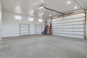 Garage featuring a garage door opener Extra Tall and Deep for holding a large boat as well as multiple vehicles