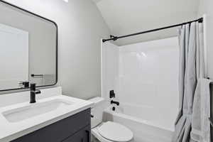 ABOVE GARAGE: Full bath featuring vanity and shower / bathtub combination with curtain