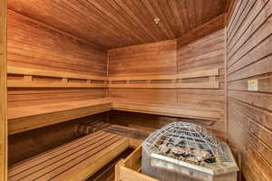 Sauna / steam room featuring wooden ceiling and wood walls