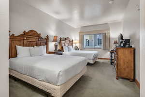 Carpeted bedroom with baseboards