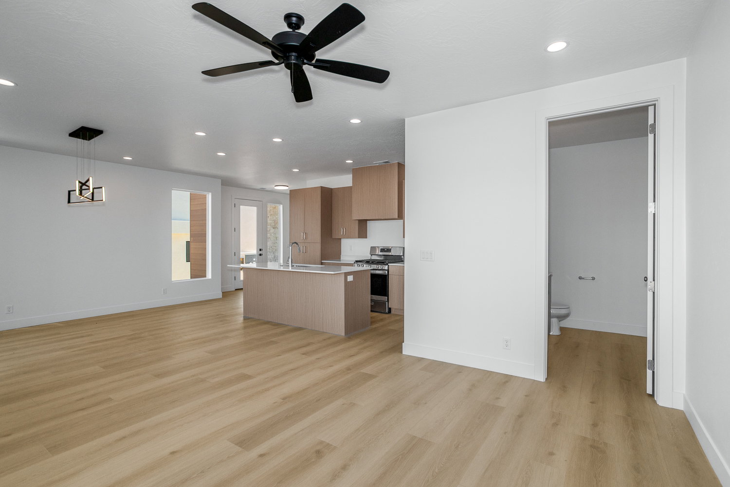Unfurnished living room with recessed lighting, light wood finished floors, and a ceiling fan
