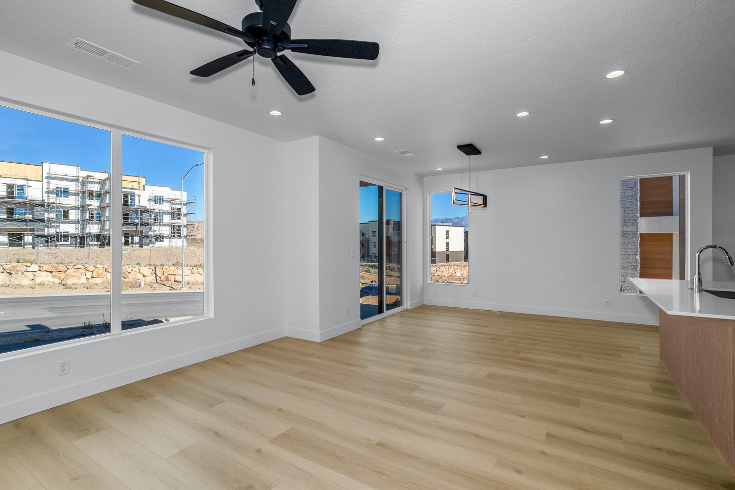 Unfurnished living room featuring light wood finished floors, recessed lighting, and ceiling fan