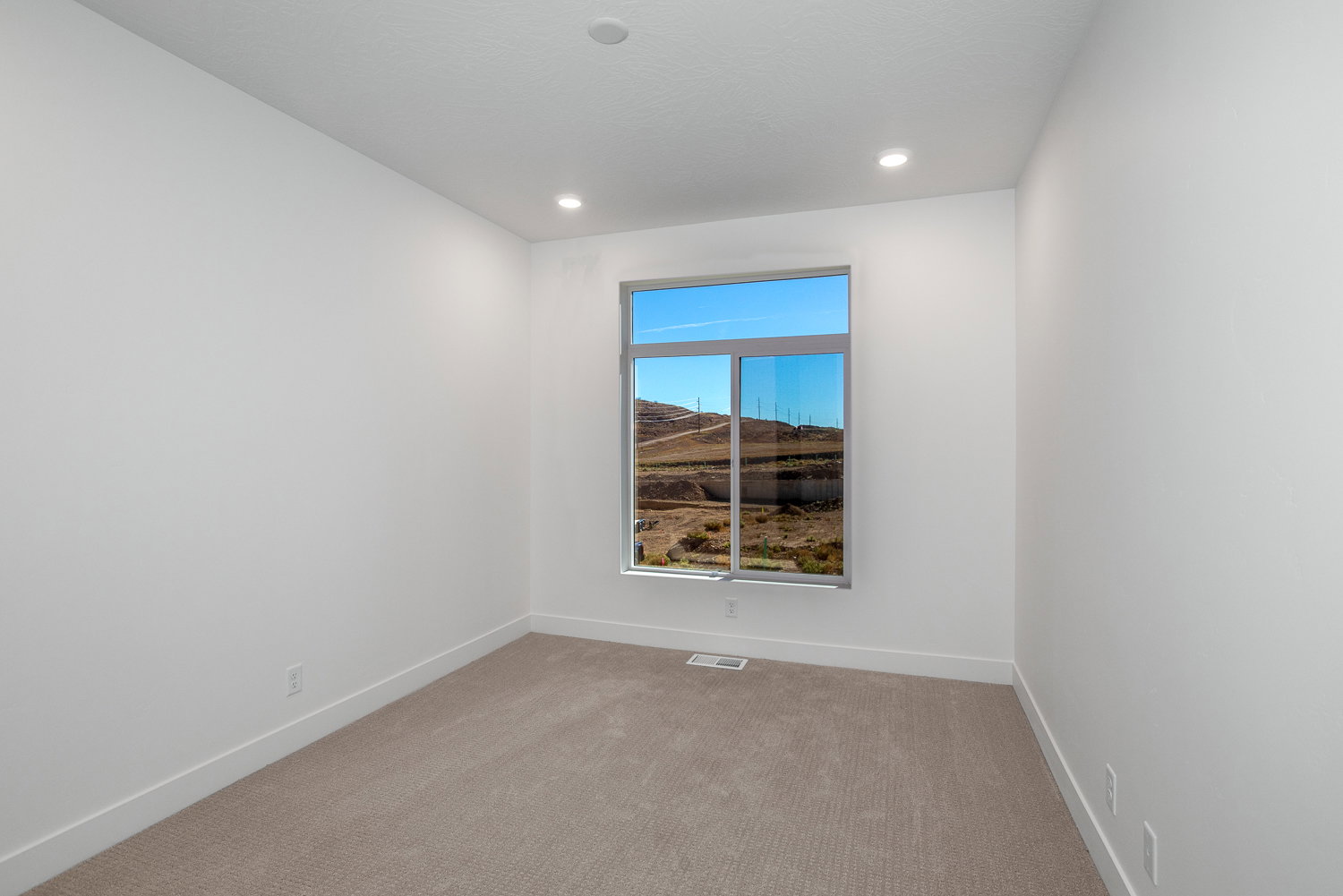 Carpeted spare room featuring baseboards and recessed lighting