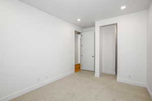 Unfurnished bedroom featuring light colored carpet and recessed lighting