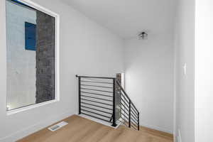 Stairway featuring wood finished floors and baseboards