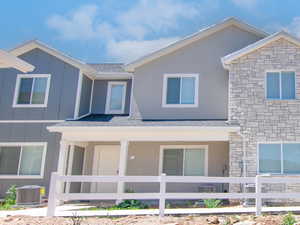 View of front facade with a porch, and board and batten siding
