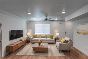 Living area with LVT flooring, recessed lighting, and ceiling fan