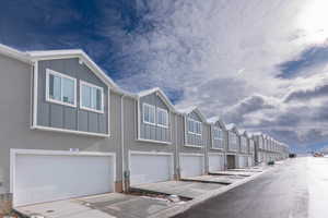 Rear view featuring 2-car garage