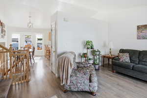 Living room with stairway and wood finished floors