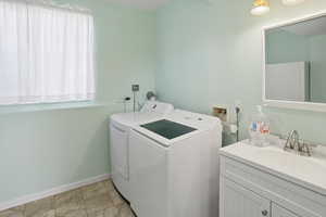 Laundry room featuring separate washer and dryer and baseboards