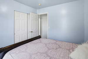 Bedroom featuring a closet and a textured ceiling