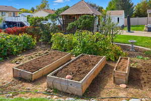 View of yard with a vegetable garden and a gazebo