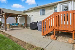 Wooden deck featuring a patio, a gazebo, grilling area, and outdoor lounge area