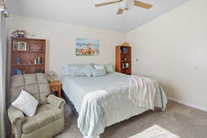 Carpeted bedroom featuring a ceiling fan and baseboards