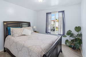 Bedroom featuring carpet flooring and baseboards
