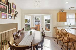 Dining area featuring light wood finished floors and recessed lighting