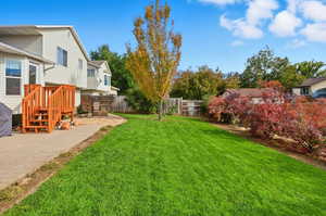 Fenced backyard with a patio
