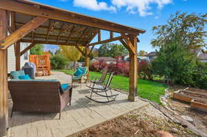 View of patio with a vegetable garden, grilling area, and an outdoor hangout area