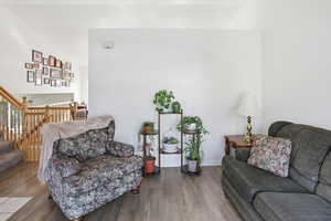 Living area with wood finished floors and stairs