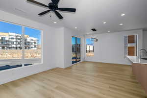Unfurnished living room featuring light wood finished floors, recessed lighting, and ceiling fan