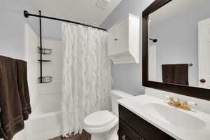 Bathroom featuring a vanity, shower / bath combo