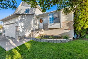 View of front of home featuring a garage, and front flower beds