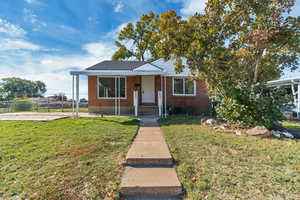 Bungalow-style home with brick siding