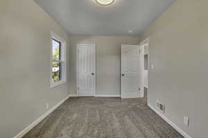 Unfurnished bedroom featuring carpet flooring and a closet
