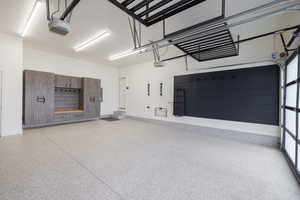 Garage with a garage door opener and baseboards