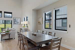 Dining area featuring light wood-style flooring and baseboards