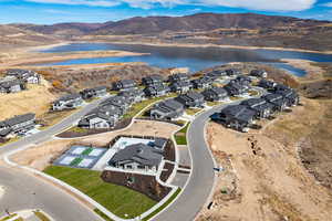 Aerial view of property's location featuring nearby suburban area and a water and mountain view