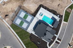 Aerial view of property and surrounding area featuring a pool area