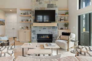 Living area featuring light wood-style floors and a large fireplace