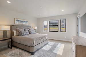 Carpeted bedroom featuring recessed lighting and baseboards