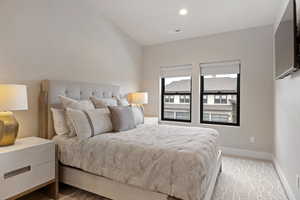 Bedroom with recessed lighting and light carpet