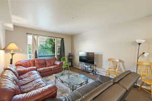 Carpeted living room featuring baseboards