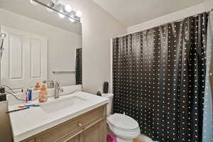 Full bath featuring vanity and a shower with curtain