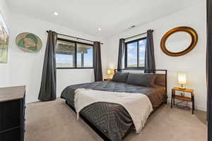 Carpeted bedroom with recessed lighting and baseboards